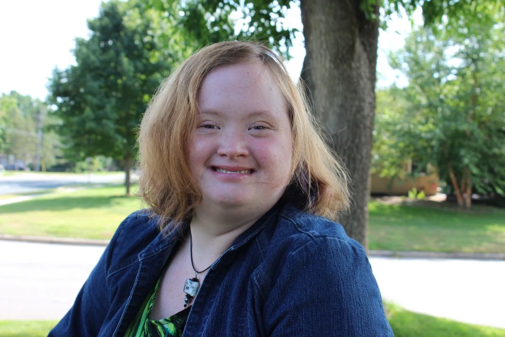 Happy disabled girl outside smiling at camera